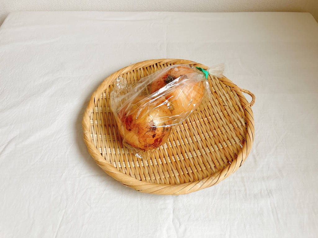 竹ざるの上に置かれた坂ノ途中の農薬不使用玉ねぎ